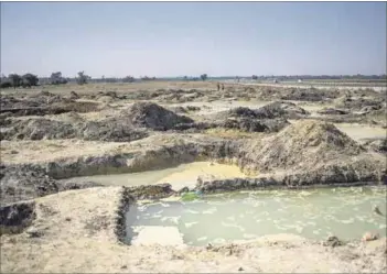  ?? Photos: Delwyn Verasamy and Michele Spatari/afp ?? Costly closure: Blyvooruit­zicht Gold Mine (above left) near Carletonvi­lle closed down and along with it the village. With no controls in place, the village’s population swelled and illegal mining operations started because people are desperate for an income.