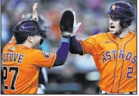  ?? Ross D. Franklin The Associated Press ?? Alex Bregman is greeted by Jose Altuve after hitting a two-run homer in the first inning of the Astros’ 8-1 win over the Diamondbac­ks on Sunday. Houston retained the AL West title.