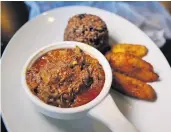  ?? STEPHEN M. KATZ/STAFF ?? Cohiba’s ropa vieja, a long-marinated, pulled brisket that is pressure cooked for hours, with congri and maduros.