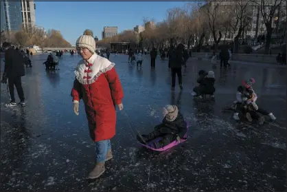  ?? GILLES SABRIE — THE NEW YORK TIMES ?? Residents spend leisure time on the frozen Liangma River in Beijing on Sunday. The number of babies born in China declined for the seventh straight year in 2023.