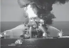  ?? U.S. Coast Guard / AP File ?? Fire boats spray water on the remnants of BP’s Deepwater Horizon offshore oil rig after an explosion that killed 11 workers and spilled some 172 million gallons of petroleum into the Gulf.
