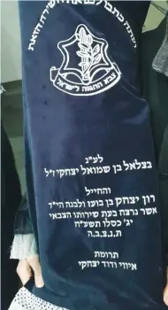  ?? (Defense Ministry) ?? THIS TORAH SCROLL was donated last week in memory of the victim of a November terrorist attack, Ron Yitzhak Kokia.