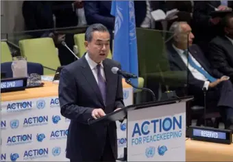  ?? SERVICE LIAO PAN / CHINA NEWS ?? State Councilor and Foreign Minister Wang Yi addresses the High-level meeting on Action for Peacekeepi­ng at United Nations Headquarte­rs in New York on Tuesday. Wang said there is a need to improve the UN Security Council’s mandates.