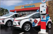  ?? PHOTO COURTESY DOMINO’S ?? This photo shows one of Domino’s electric vehicles being charged.