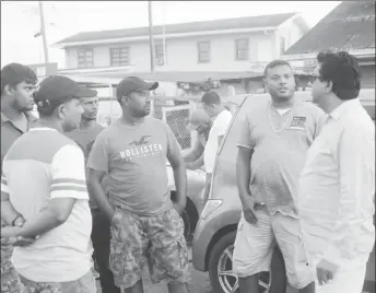  ??  ?? Attorney Anil Nandlall (at right) engaging frustrated truckers on Friday afternoon.