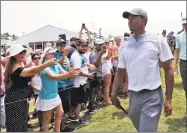  ?? Lynne Sladky / Associated Press ?? Tiger Woods walks off the 18th hole during the third round of the Players Championsh­ip on Saturday.