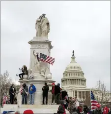  ?? THE ASSOCIATED PRESS ?? Supporters of President Donald Trump climb the Peace Monument, also known as the Naval Monument or Civil War Sailors Monument, during a rally at the U.S. Capitol on Wednesday, Jan. 6, 2021, in Washington.