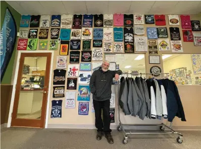  ?? The Associated Press ?? ■ Wayne Holly, the owner of Rio Rancho T-Shirts, stands at the family-owned shop Monday in Rio Rancho, N.M. Holly said the small business he and his wife have operated for more than 20 years has been dramatical­ly affected by the rising cost of materials. He said he and his wife are heartbroke­n that they have to pass those costs onto customers.