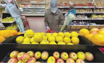  ?? — Reuters ?? A person shops at a Trader Joe’s grocery store in the Manhattan borough of New York City, New York.