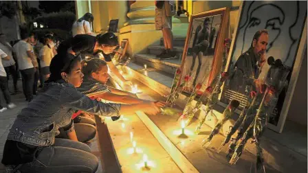  ??  ?? Solemn goodbye: Students lighting candles in honour of Castro a day after his death, at the Havana University in Havana. — AFP