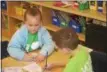  ??  ?? Finley Hennessey, 6, creates a thank you card for a soldier.