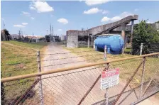  ??  ?? A gate at the U.S. Oil Recover Superfund site is seen Sept. 14 in Pasadena, Texas, where 3 tanks used to store toxic waste flooded.