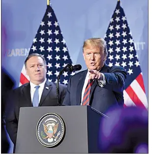  ?? AP/GEERT VANDEN WIJNGAERT ?? With Secretary of State Mike Pompeo beside him Thursday, President Donald Trump says at a news conference after a meeting of NATO leaders in Brussels that he believes in NATO but Western allies need to increase their defense spending.