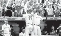  ?? Associated Press ?? ■ Toronto Blue Jays Jose Bautista celebrates with teammate Troy Tulowitzki after he hit a solo home run against the New York Yankees during the fourth inning of their baseball game Sunday in Toronto.