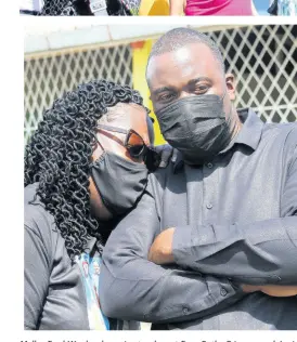  ??  ?? Melba Ford-Woolcock, senior teacher at Four Paths Primary and Junior High had to lean on Eswick Dorway, guidance councillor as she was overcome with emotion at a remembranc­e service at the school for Nattalie Dawkins on Thursday.