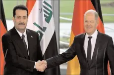  ?? -AFP ?? BERLIN
German Chancellor Olaf Scholz (R) and Iraq’s Prime Minister Mohammed Shia al-Sudani shake hands at the end of a joint press conference following talks at the Chanceller­y.