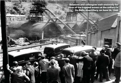  ??  ?? > Relatives and colleagues wait anxiously for news of the trapped miners at the colliery in Six Bells, Abertiller­y, on June 28, 1960