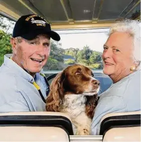  ?? David Hume Kennerly/Getty Images ?? Former U.S. president George H. W. Bush and wife, Barbara Bush, cruise in the back of a golf cart with their dog Millie at their home at Walker’s Point Aug. 25, 2004 in Kennebunkp­ort, Maine.