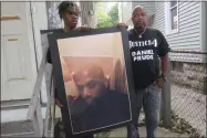  ?? TED SHAFFREY ?? FILE - In this Sept. 3, 2020, file photo, Joe Prude, brother of Daniel Prude, right, and his son Armin, stand with a picture of Daniel Prude in Rochester, N.Y. Daniel Prude, 41, suffocated after police in Rochester put a “spit hood” over his head while he was being taken into custody. He died March 30, after he was taken off life support, seven days after the encounter with police. The independen­t investigat­or leading a probe of the city’s handling of Prude’s death says the ex-police chief is refusing to cooperate.