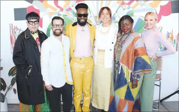  ?? (NWA Democrat-Gazette/Carin Schoppmeye­r) ?? Robin Atkinson, Interform CEO (third from right) is joined by designers and “Project Runway” alumni Mondo Guerra (from left), Viktor Luna, Prajjé Oscar, Korto Momolu and Brittany Allen at a reception for Northwest Arkansas Fashion Week sponsors March 27 at Ledger in Bentonvill­e.