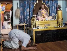  ?? The New York Times/MARK ABRAMSON ?? A sculpture of Srila Prabhupada, the founder of the Hare Krishna Society, sits at Sri Sri Krishna-Balaram Mandir, a temple in New York.