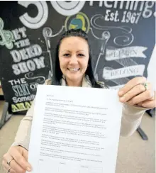  ?? JASON BAIN/EXAMINER ?? Fleming College third-year child and youth care student Jennifer Bernard holds up a copy of a petition she is encouragin­g others to sign to show their support for regulation of the unregulate­d field at the Sutherland Campus on Wednesday. She created a...
