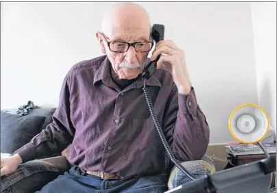  ?? MILLICENT MCKAY/JOURNAL PIONEER ?? Elmer Canning answers his phone after reading the call display to determine if it was a number he recognized.