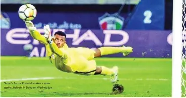  ??  ?? Oman’s Faiz al Rushaidi makes a save against Bahrain in Doha on Wednesday