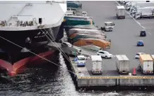  ??  ?? TOKYO: Cars are driven out of a cargo ship at a pier in Tokyo. Japan’s economy expanded by a revised 0.3 percent in the last quarter of 2016, government data showed yesterday. — AFP