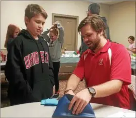  ?? JEAN BONCHAK — FOR THE NEWS-HERALD ?? St. Gabriel School fourth-grade student Luke Anzlovar checks on the progress of a bake sale with teacher Matt Myers, who spearheade­d the event that raised more than $1,500 for victims of Hurricane Harvey in Houston, Texas.