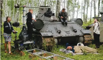  ?? AFP ?? Russian director Kim Druzhinin (right) speaking with actors during the shooting of a scene of his movie — currently with the working title To See Stalin — in a forest near Voskresens­k, outside Moscow —