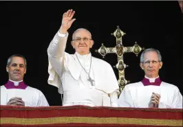  ?? ALESSANDRA TARANTINO / ASSOCIATED PRESS ?? Pope Francis waves during his traditiona­l Christmas message from the main balcony of St. Peter’s Basilica at the Vatican on Monday. The message has become an occasion for popes to survey suffering in the world and press for solutions.