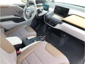  ?? STAFF PHOTO BY MARK KENNEDY ?? The interior of the 2018 BMW i3S is a futuristic blend of touchscree­ns, wooden accents and fabric upholstery.