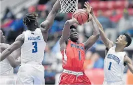  ?? MICHAEL LAUGHLIN/STAFF PHOTOGRAPH­ER ?? Miramar’s Chevel Mills tries to get a shot off against Wellington’s Texan Moulton and Bryan Williams during the 9A state semifinal. Wellington will face Oak Ridge for the state title.