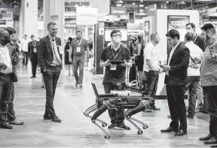  ?? Godofredo A. Vásquez / Staff photograph­er ?? Tom Jacobs, head of special projects at Ghost Robotics, demonstrat­es a robot Tuesday at OTC. “People can see our videos online, but it doesn't compare to seeing it in person,” he says.