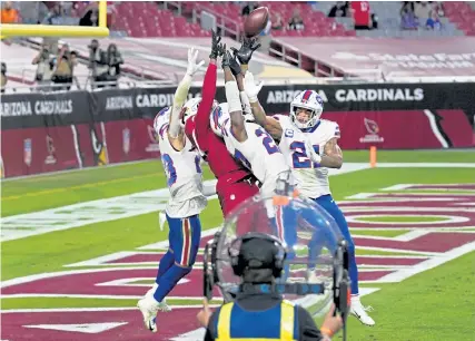  ?? Ross D. Franklin, The Associated Press ?? Cardinals wide receiver DeAndre Hopkins catches the game- winning touchdown while swarmed by Bills defenders during the final moments of their game Sunday in Glendale, Ariz.