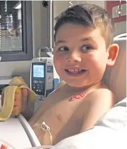  ??  ?? Schoolboy Milo Carter enjoys his first banana for two years after the operation that saw him receive one of his mother’s kidneys.