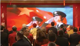  ??  ?? Canadian Prime Minister Justin Trudeau and Minister of Defense stand in salute to the PLA at a dinner in Vancouver, in 2019, following the arrest of Meng two months earlier. (Still from video)