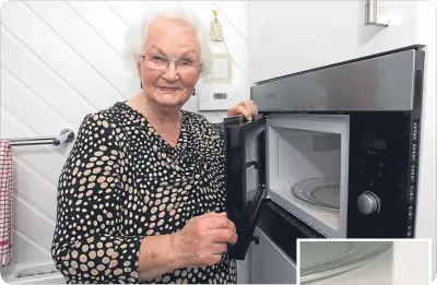  ??  ?? May has had her stained microwave (right) replaced.