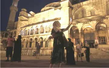  ??  ?? A visitor uses her smartphone to take a photograph at the Sultanahme­t mosque in Istanbul. — Bloomberg photo by Kostas Tsironis