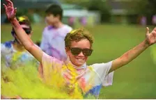  ??  ?? Charlie Waters laps it up at the colour fun run at Rangeville State School.