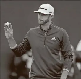  ?? Matt Dunham/ AP ?? Dustin Johnson of the United States acknowledg­es the crowd as he walks off the 18th green after completing his second round of the British Open Golf Championsh­ips at the Royal Troon Golf Club in Troon, Scotland, Friday, July 15, 2016.