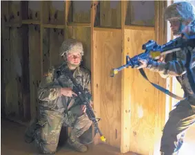  ?? JOHN BAZEMORE /ASSOCIATED PRESS ?? U.S. Army recruit Kirsten practices building clearing tactics with male recruits at Fort Benning, Ga. She’s one of a handful of women training to become infantry soldiers. The introducti­on of women into the infantry has moved steadily but cautiously...