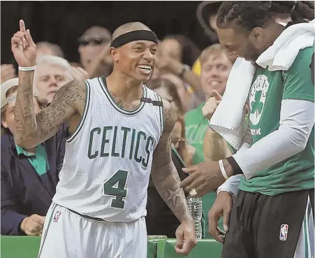  ?? STAFF PHOTO BY MATT STONE ?? HAPPY DAZE: Isaiah Thomas celebrates with Jae Crowder in the closing minutes of the Celtics’ win over the Wizards in Game 5 last night at the Garden.