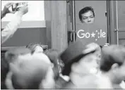  ?? Saul Loeb AFP/Getty Images ?? A PROTESTER watches Google CEO Sundar Pichai give answers before the House Judiciary Committee.