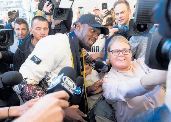  ?? Photo / Getty Images ?? Usain Bolt arrives in Sydney, surrounded by fans and the media, for his A-League trial with the Central Coast Mariners.