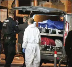  ?? DAVID YOUNG/DPA/AFP ?? A body bag on a stretcher is being loaded into a van as investigat­ors work at the square where a man rammed his car into a crowd killing two and injuring several others the night before in Muenster, western Germany, on Saturday.