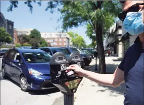  ?? Tyler Sizemore / Hearst Connecticu­t Media file photo ?? Stamford’s Felice Donatiello feeds the parking meter along Greenwich Avenue in downtown Greenwich on July 6, 2020.