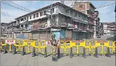  ??  ?? A CRPF jawan stands guard during curfew in Srinagar on Tuesday.