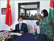  ?? TONY KARUMBA / AFP ?? Chinese State Councilor and Foreign Minister Wang Yi is received by Raychelle Omamo, Kenya’s cabinet secretary for foreign affairs, in Mombasa on Thursday.